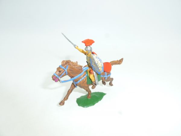Roman on horseback with sword, shield + cape