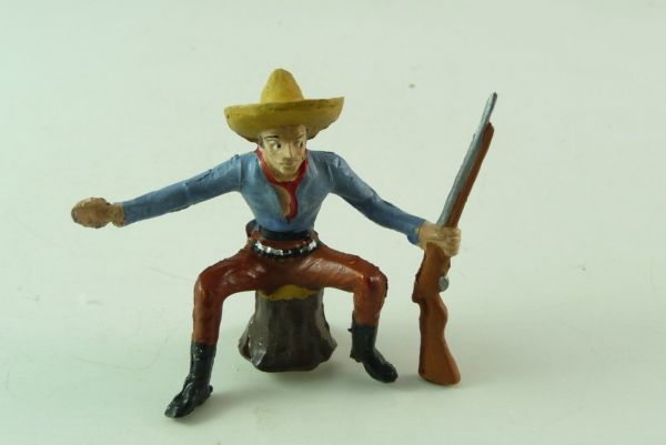Merten Cowboy with rifle on tree trunk