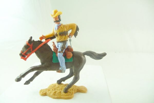 Timpo Toys Cowboy 4th version riding, pulling a pistol, with fringed shirt