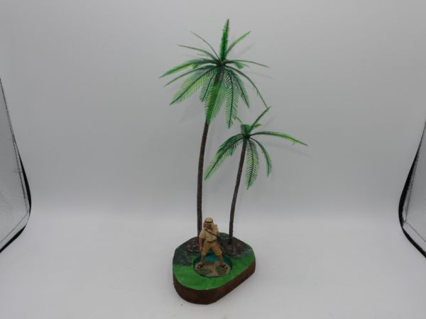 Arab soldier with machine gun in front of palm tree diorama