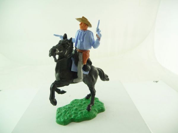 Timpo Toys Cowboy 1. Version reitend, 2 Pistolen wild schießend, hellblau