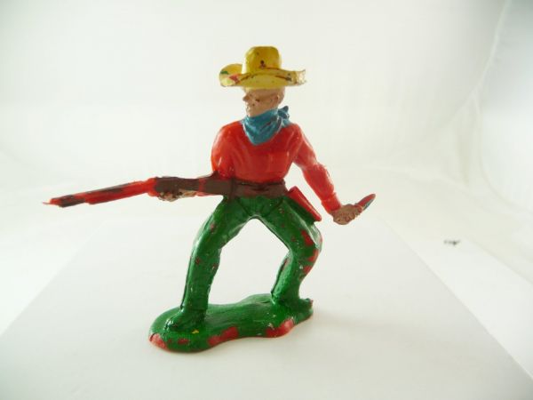 Crescent Cowboy firing with rifle from the hip and knife