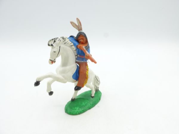 Indian on horseback, shooting rifle sideways