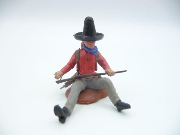 Britains Swoppets Cowboy sitting at a tree trunk (red shirt)