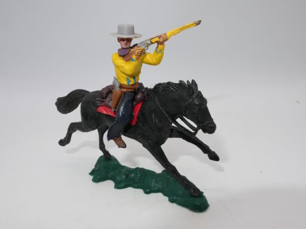 Britains Swoppets Cowboy (yellow) on horseback shooting rifle