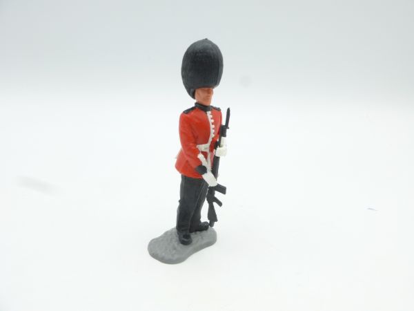 Timpo Toys Guardsman marching, presenting rifle