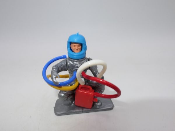 Astronaut kneeling with accessories