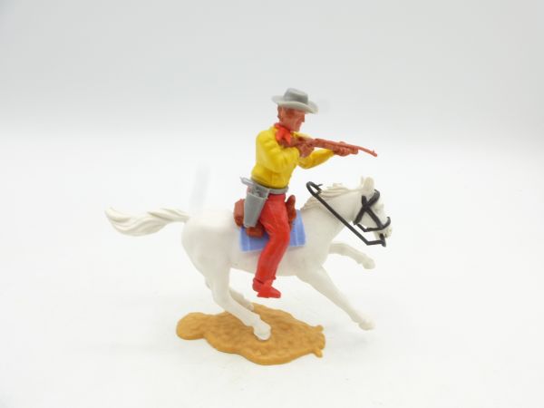 Timpo Toys Cowboy reitend, mit Gewehr schießend (gelbes Hemd)