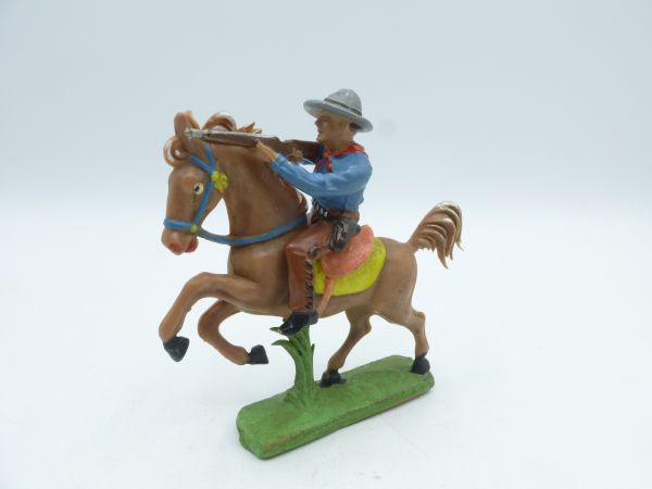 Cowboy riding, shooting rifle