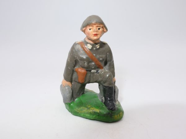 Soldier (compound) kneeling with cases