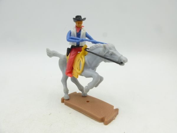 Plasty Cowboy riding, shooting rifle