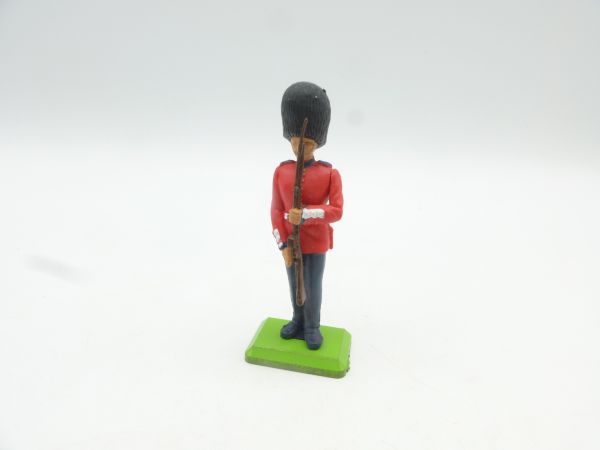 Britains Deetail Guardsman standing presenting rifle