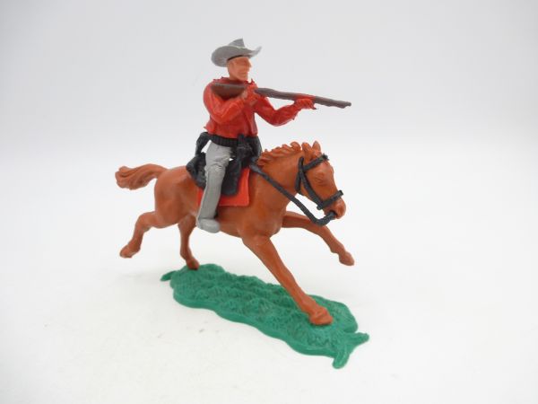 Timpo Toys Cowboy 1. Version (kleiner Hut) reitend, Gewehr schießend