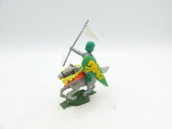 Medieval knight riding with flag + shield, green