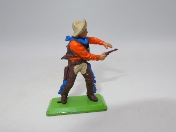 Britains Deetail Cowboy shooting pistol with both hands, orange shirt