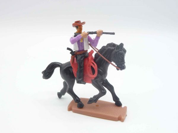 Plasty Cowboy riding, firing rifle, with loose rifle