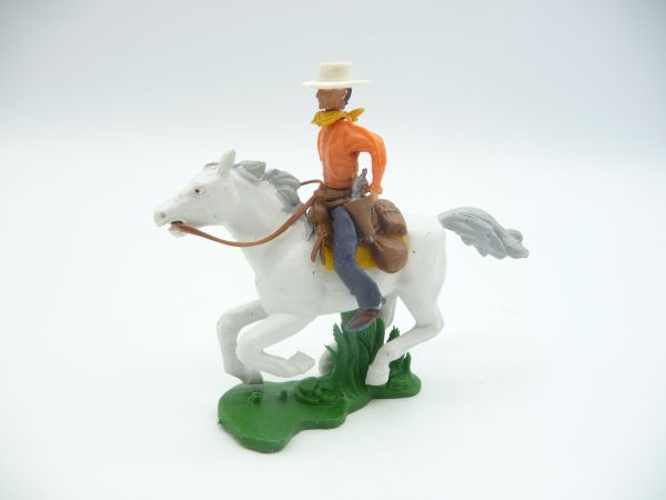 Britains Swoppets Cowboy on horseback, both hands on gun belt (orange shirt)