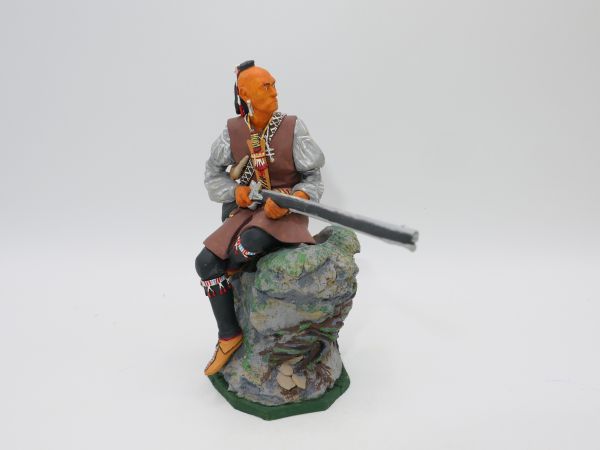Iroquois sitting on stone with rifle, total height 13 cm, material resin