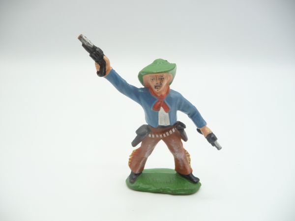 Cowboy standing, firing 2 pistols into the air