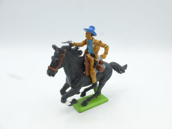 Britains Deetail Cowboy riding, pulling 2 pistols