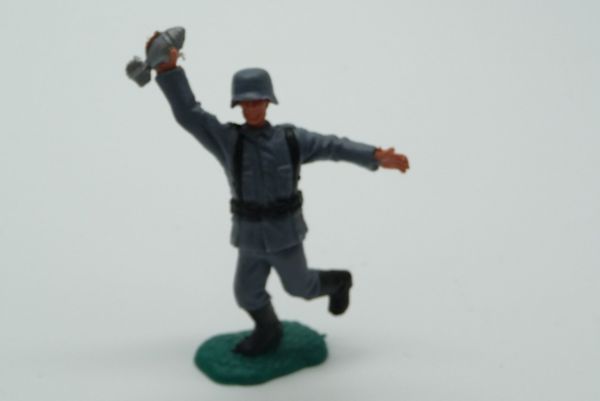 Timpo Toys German soldier (loose helmet), holding up grenade