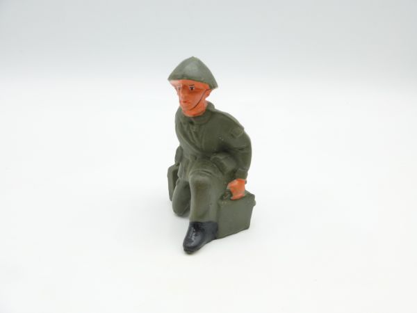 Soldier kneeling with ammunition case