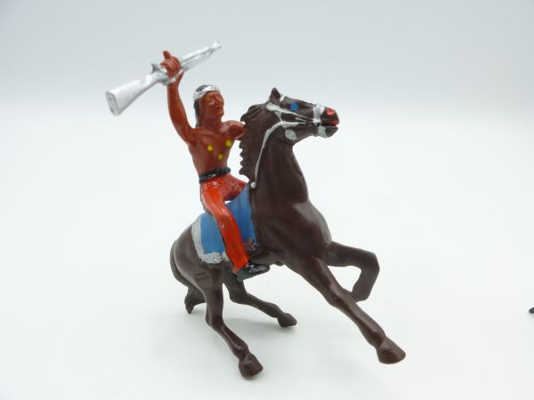Heimo Indian riding with knife, holding rifle in the air