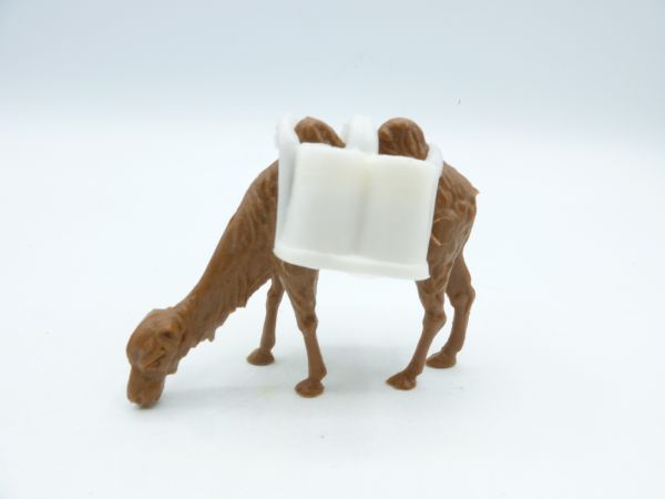 Heinerle Camel, dark brown, grazing with white sacks as carrying load