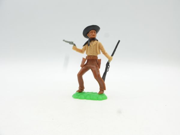 W. Germany Cowboy standing with pistol + rifle