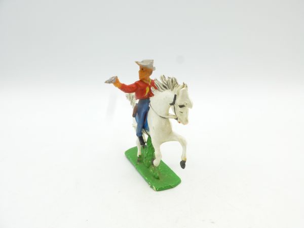 Cowboy riding, shooting pistol, red shirt