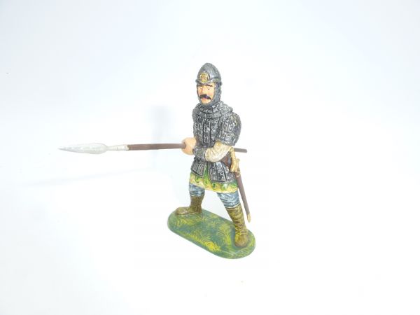 Norman standing, holding spear with both hands at the side