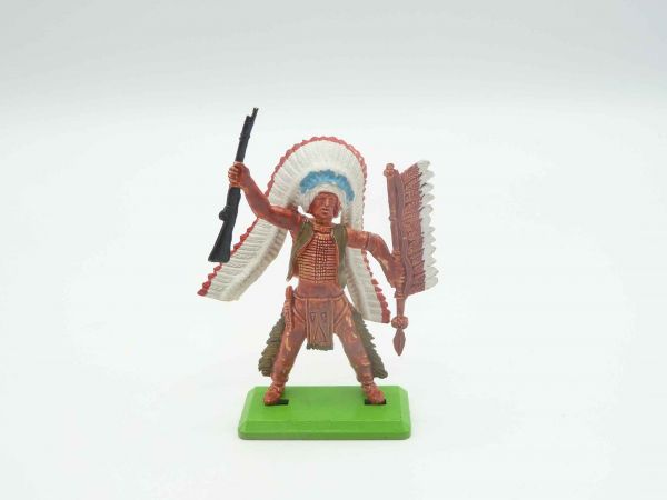 Britains Deetail Indian standing with long feather headdress, rifle raised