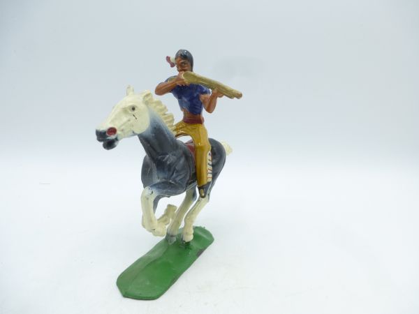 Indian on horseback, firing rifle sideways