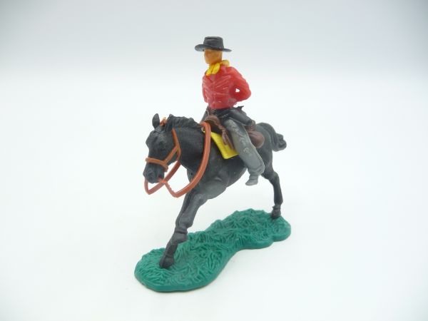 Cowboy riding with hands tied behind his back, red