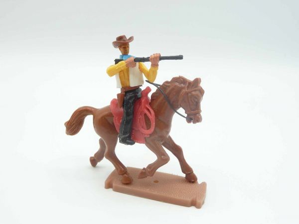 Plasty Cowboy riding, firing a rifle, with loose rifle