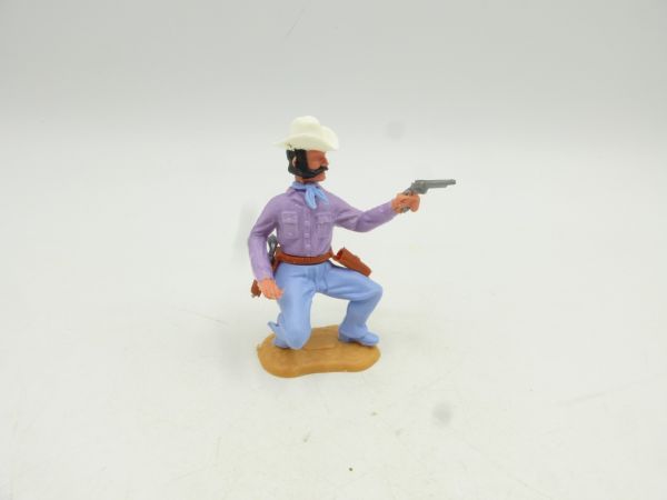 Timpo Toys Cowboy 3. Version hockend, Pistole schießend