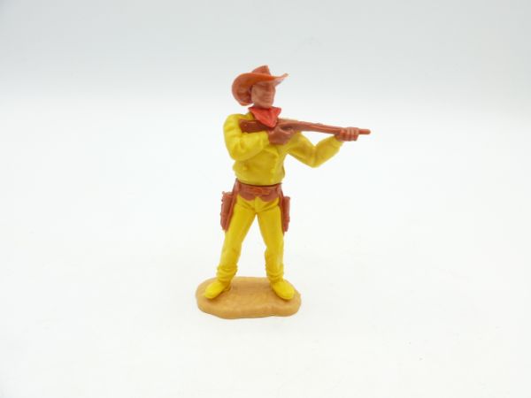 Timpo Toys Cowboy standing, firing with short rifle, dark yellow