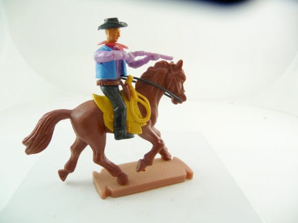 Plasty Cowboy riding, firing with rifle