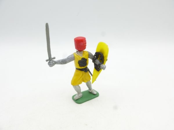 Medieval knight standing with sword + shield, yellow