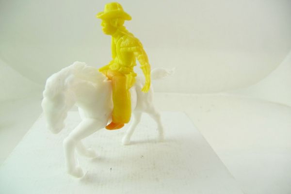 Heinerle / Domplast Cowboy on horseback, pulling pistol, yellow with colour gradient at feet