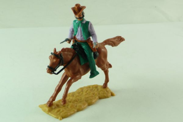 Timpo Toys Cowboy 3rd version, riding, on rare dark-green lower part