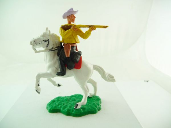 Timpo Toys Cowboy 1. Version reitend, Gewehr schießend, dunkelgelb