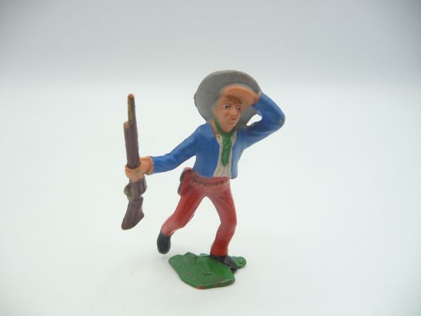 Cowboy with rifle going ahead, peering (blue jacket)