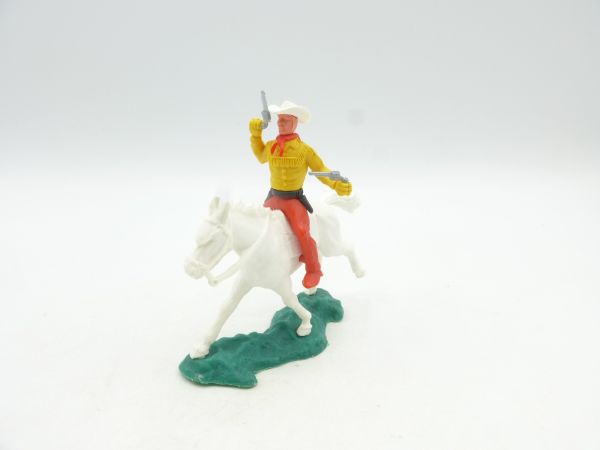 Crescent Cowboy on horseback, firing 2 pistols wildly