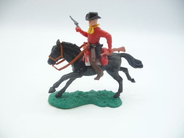 Cowboy riding with rifle + pistol, red