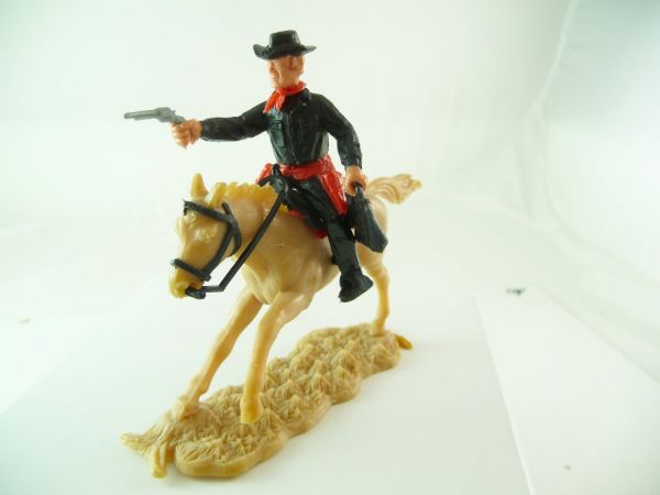 Timpo Toys Cowboy reitend, schwarzes Unterteil mit rotem Holster