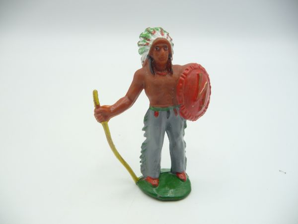 Indian chief standing with spear + shield, grey trousers, red shield