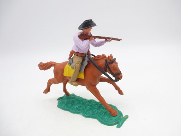 Timpo Toys Cowboy 1. Version (kleiner Hut) reitend, Gewehr schießend