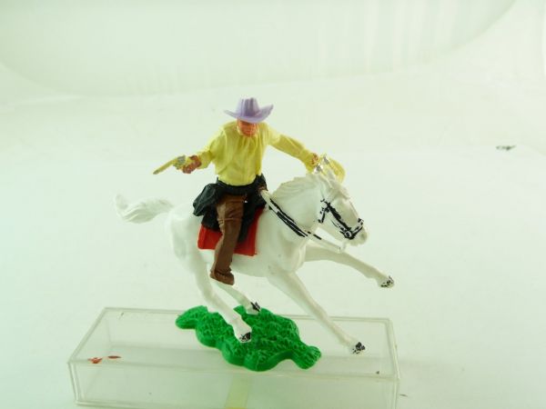 Timpo Toys Cowboy reitend mit Pistole + Geldtasche, Oberteil hellgelb
