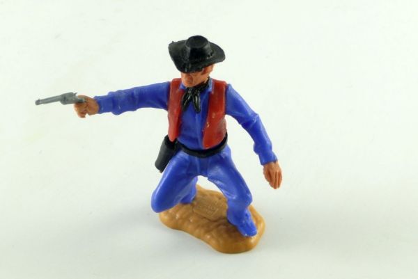 Timpo Toys Cowboy mittelblau-rote Weste hockend 1 Pistole schießend 3. Version